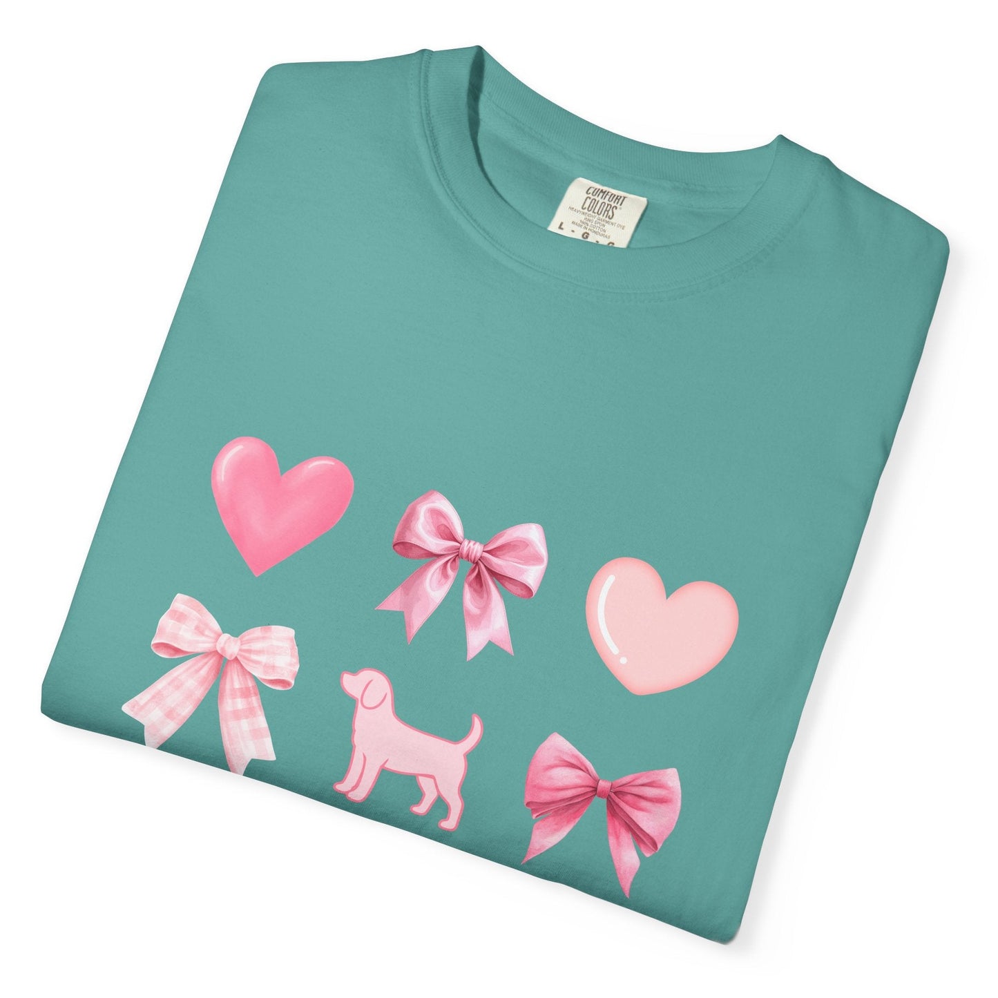 Folded seafoam short sleeve shirt with pink hearts, bows, and a beagle graphic